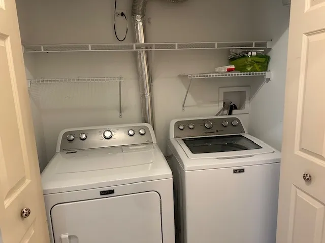 a view of storage and utility room with washer and dryer