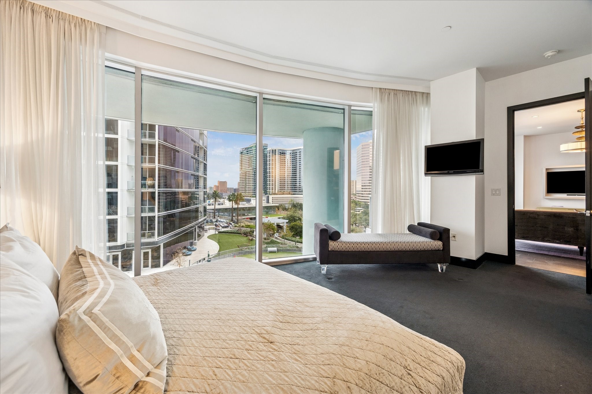 1600 Post Oak Boulevard, Unit 1007 Houston, TX 77056 - Photo 10 of 14 a bedroom with a bed and a flat tv screen next to a window