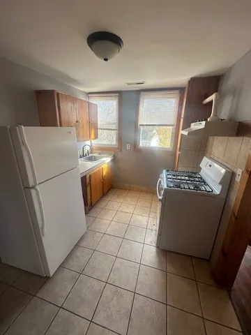 a view of a room with a fireplace and wooden floor