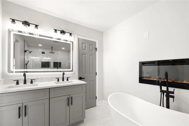 a bathroom with a tub sink and mirror
