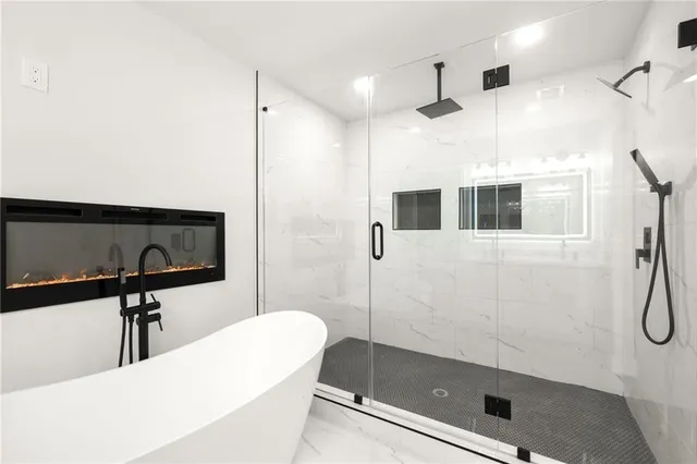 a bathroom with a bathtub and a shower