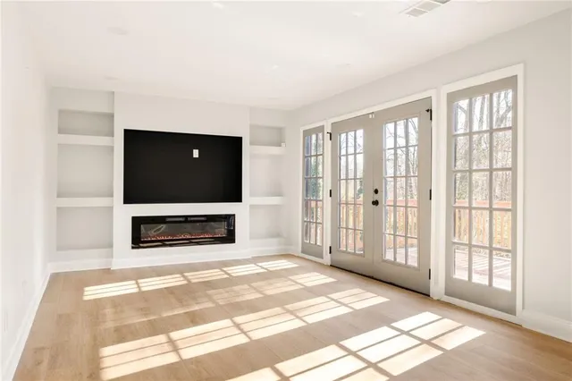 a living room with a fireplace and a flat screen tv
