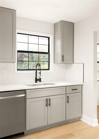 a kitchen with white cabinets white appliances and a sink