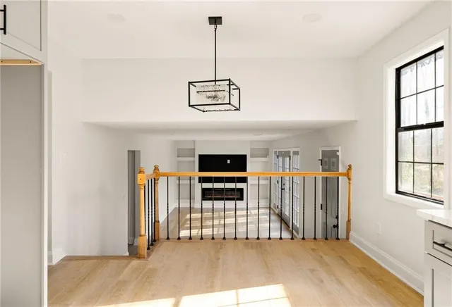 a view of a livingroom with entryway wooden floor and window