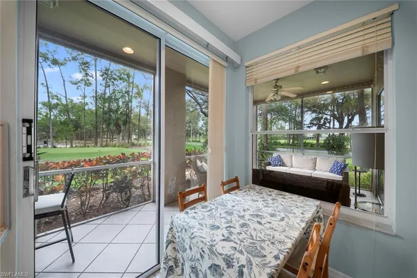 a bedroom with furniture and large windows