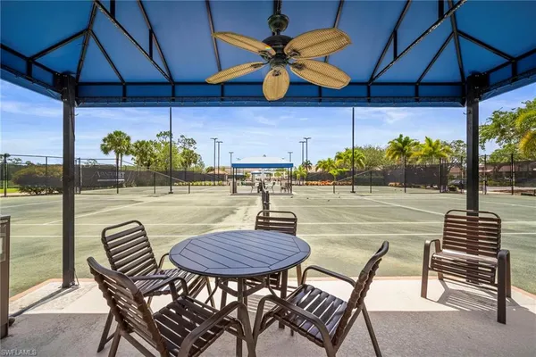 a view of a patio with a table and chairs