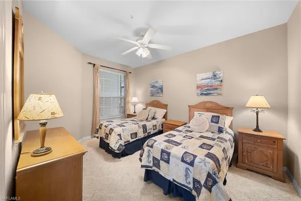 a bedroom with two beds and a window