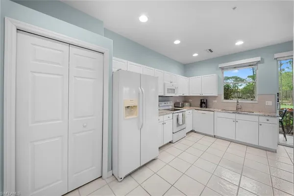 a kitchen with white cabinets