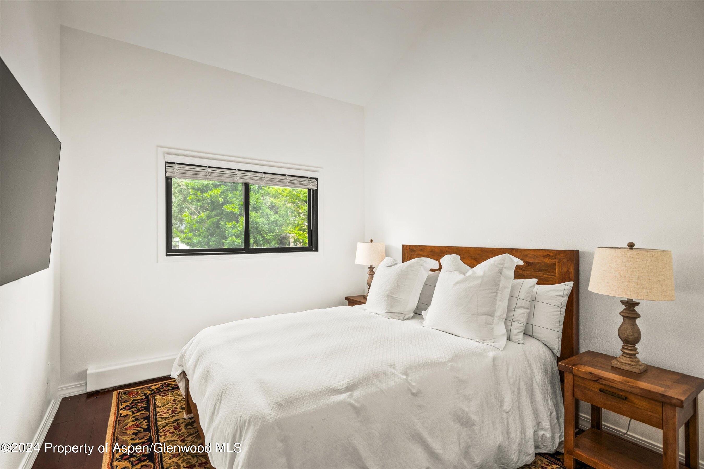 2024 Arbor Park Drive Basalt, CO 81621 - Photo 10 of 16 a bedroom with a bed and wooden floor