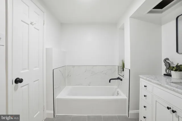 a bathroom with a bathtub and shower