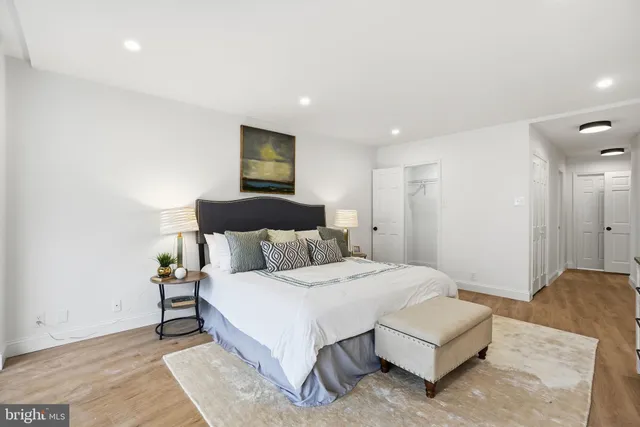 a spacious bedroom with a bed and a couch