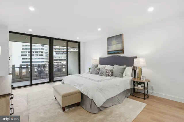 a bedroom with a large bed and a large window