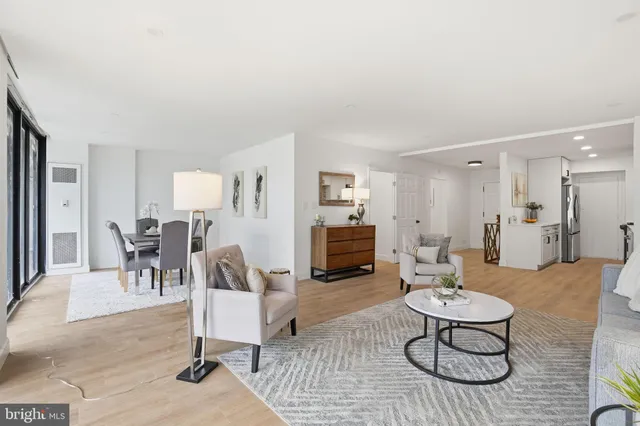 a living room with furniture a dining table and chairs with kitchen view