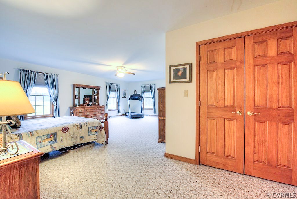 2923 Ashdale Road Center Cross, VA 22437 - Photo 18 of 45 Master bedroom with carpet, closets, fan/fixture,