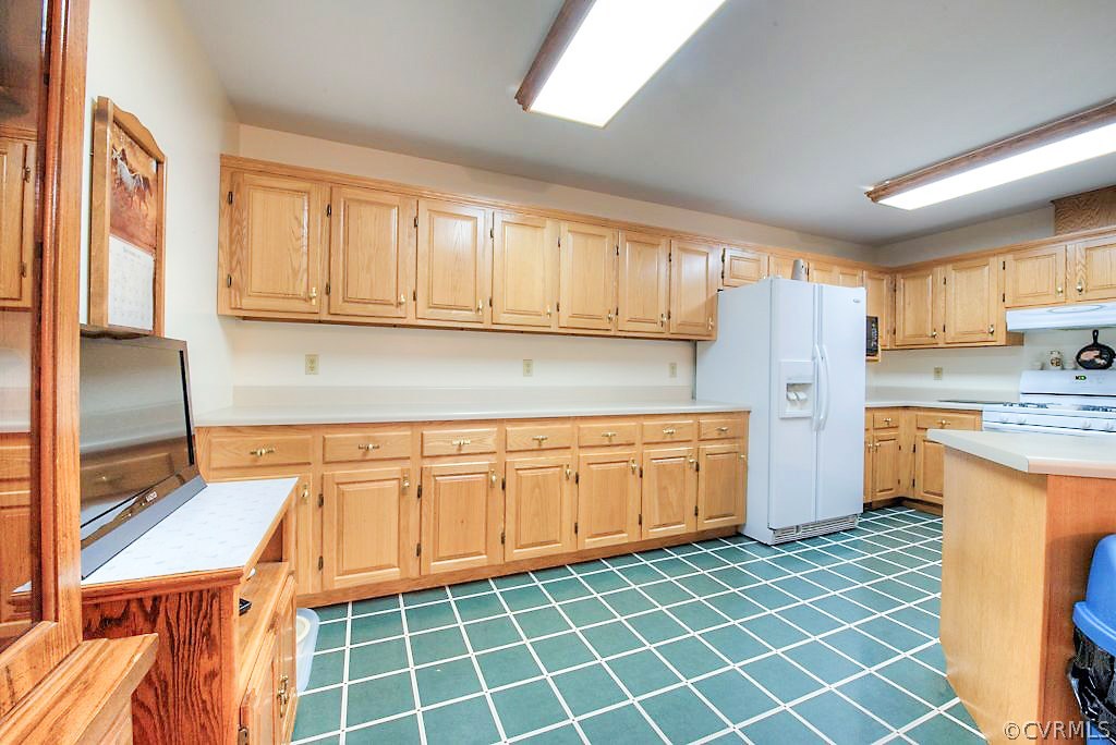 2923 Ashdale Road Center Cross, VA 22437 - Photo 10 of 45 Kitchen with wood cabinets, gas cooking, laminate