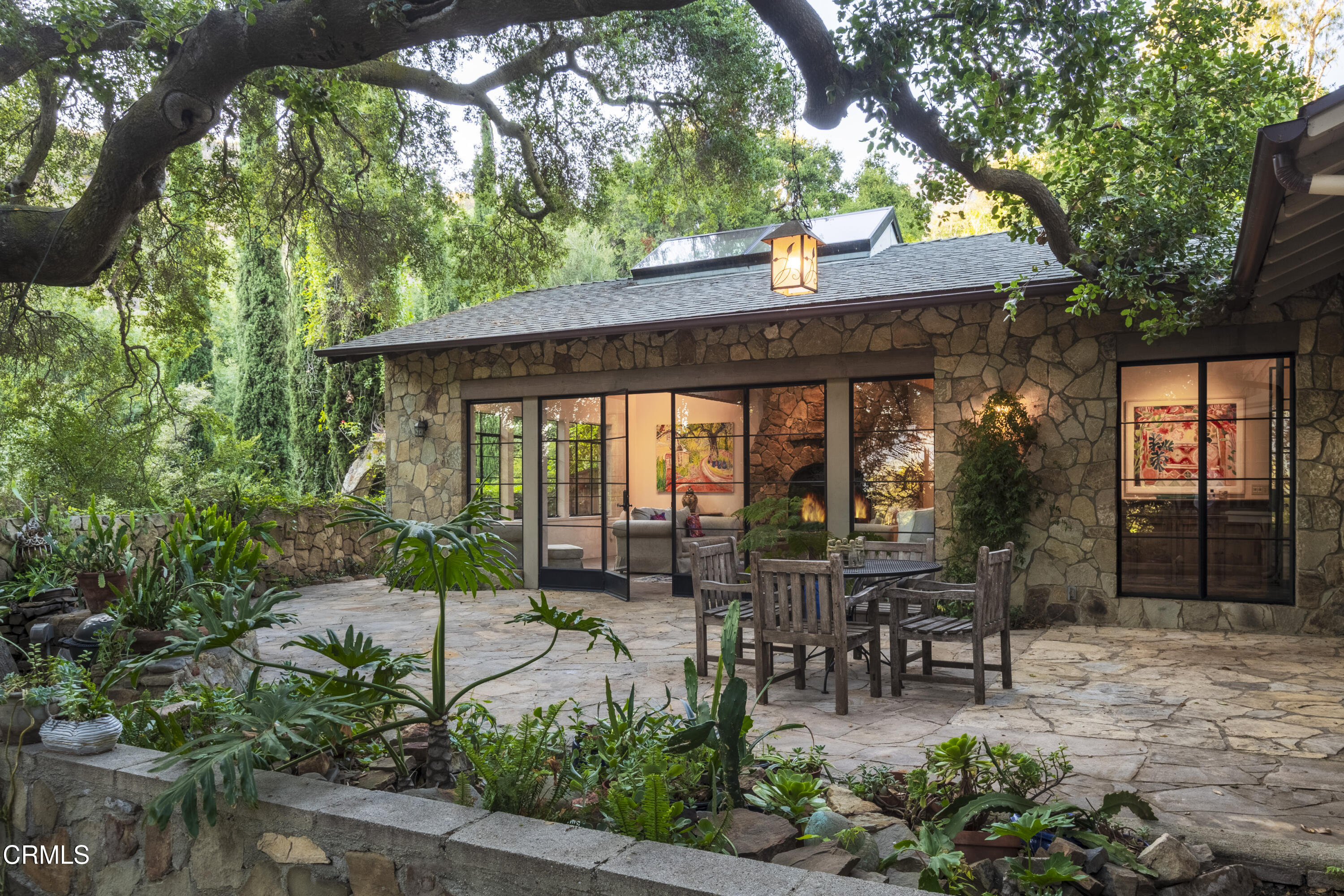 12615 Koenigstein Road Santa Paula, CA 93060 - Photo 4 of 41 a view of a patio with table and chairs potted plants and large tree