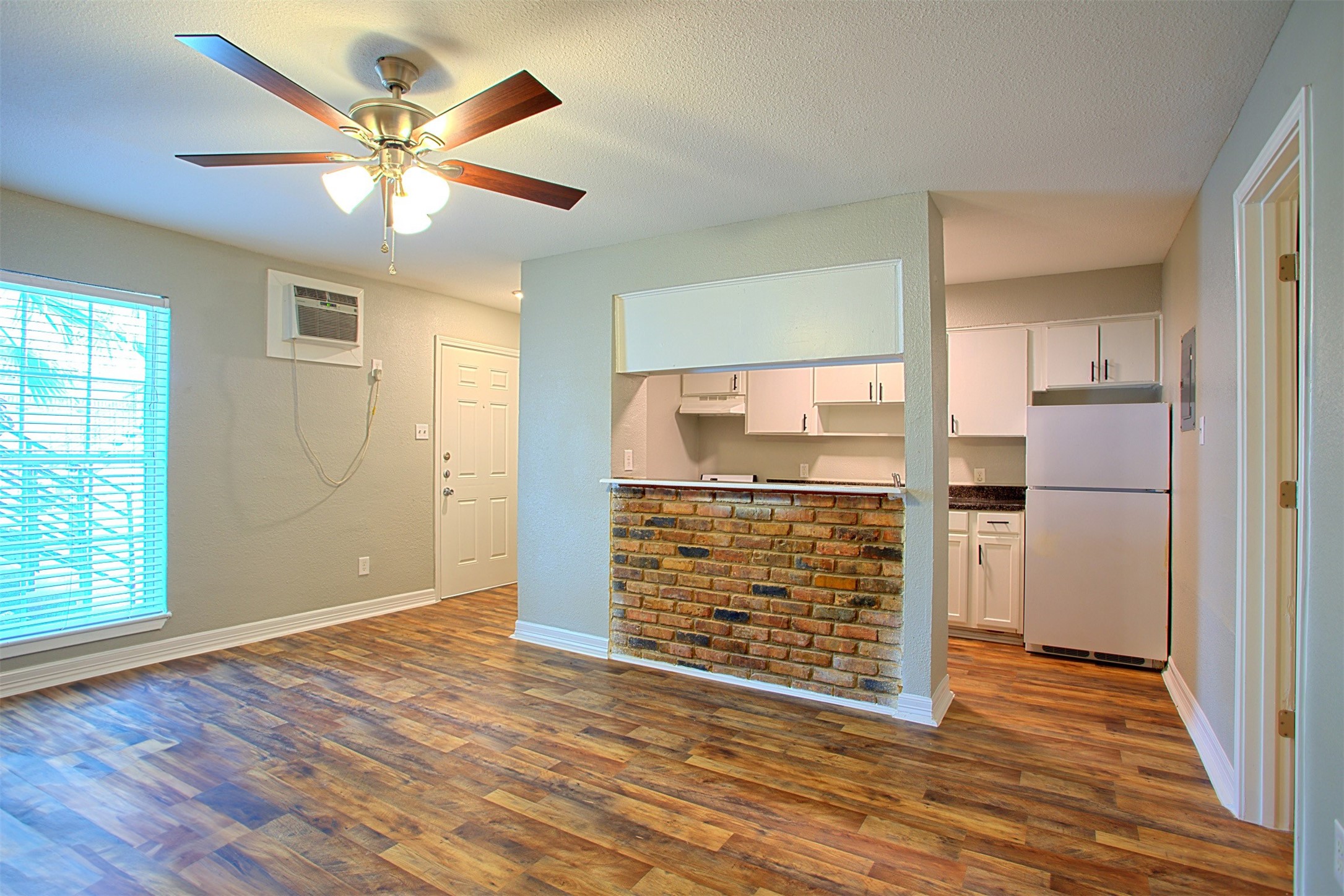 1419 Hawthorne Street, Unit 9 Houston, TX 77006 - Photo 2 of 24 an empty room with wooden floor a ceiling fan and windows