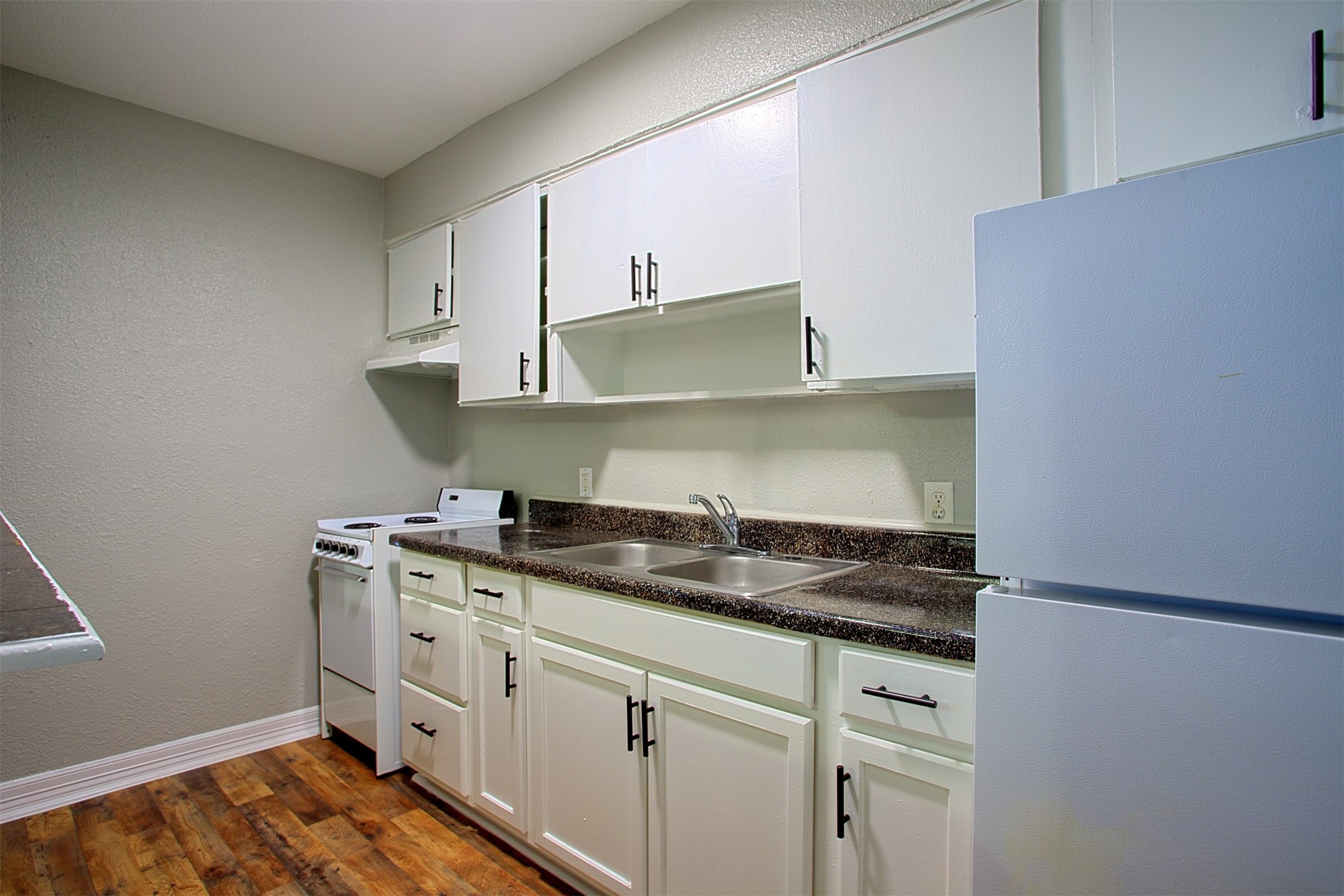 1419 Hawthorne Street, Unit 9 Houston, TX 77006 - Photo 3 of 24 a kitchen with stainless steel appliances granite countertop a sink stove and cabinets