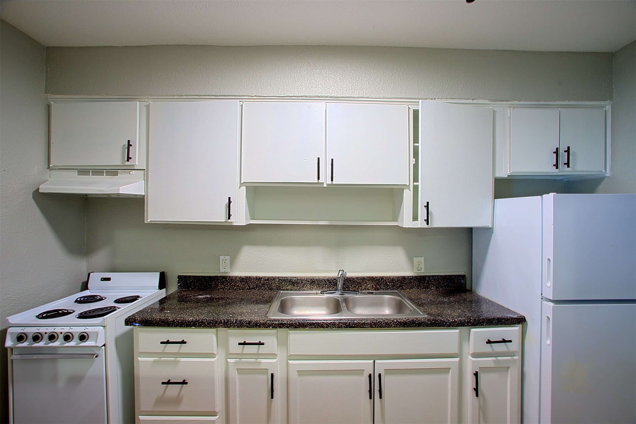 1419 Hawthorne Street, Unit 9 Houston, TX 77006 - Photo 4 of 24 a kitchen with granite countertop a sink stove and cabinets