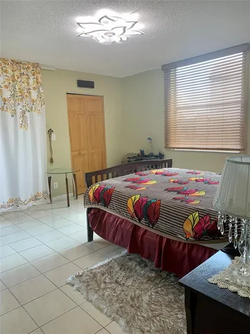 a bathroom with a sink a toilet a mirror and shower