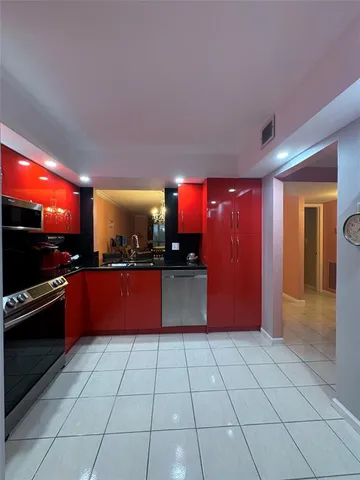 a kitchen with stainless steel appliances granite countertop a refrigerator and a stove