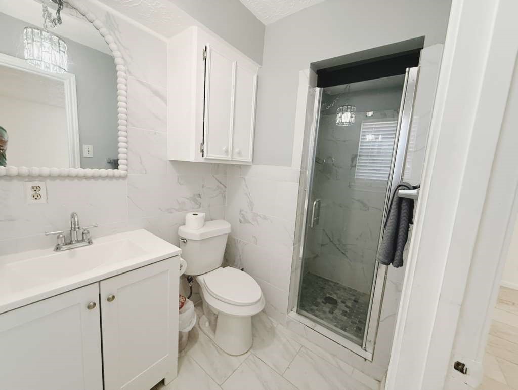 9231 Friendship Road Houston, TX 77080 - Photo 11 of 12 a bathroom with a sink a toilet and shower