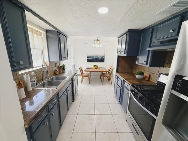 a kitchen with a sink appliances and cabinets