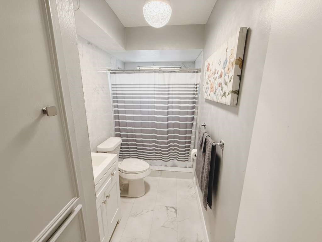 9231 Friendship Road Houston, TX 77080 - Photo 8 of 12 a bathroom with a toilet and a shower