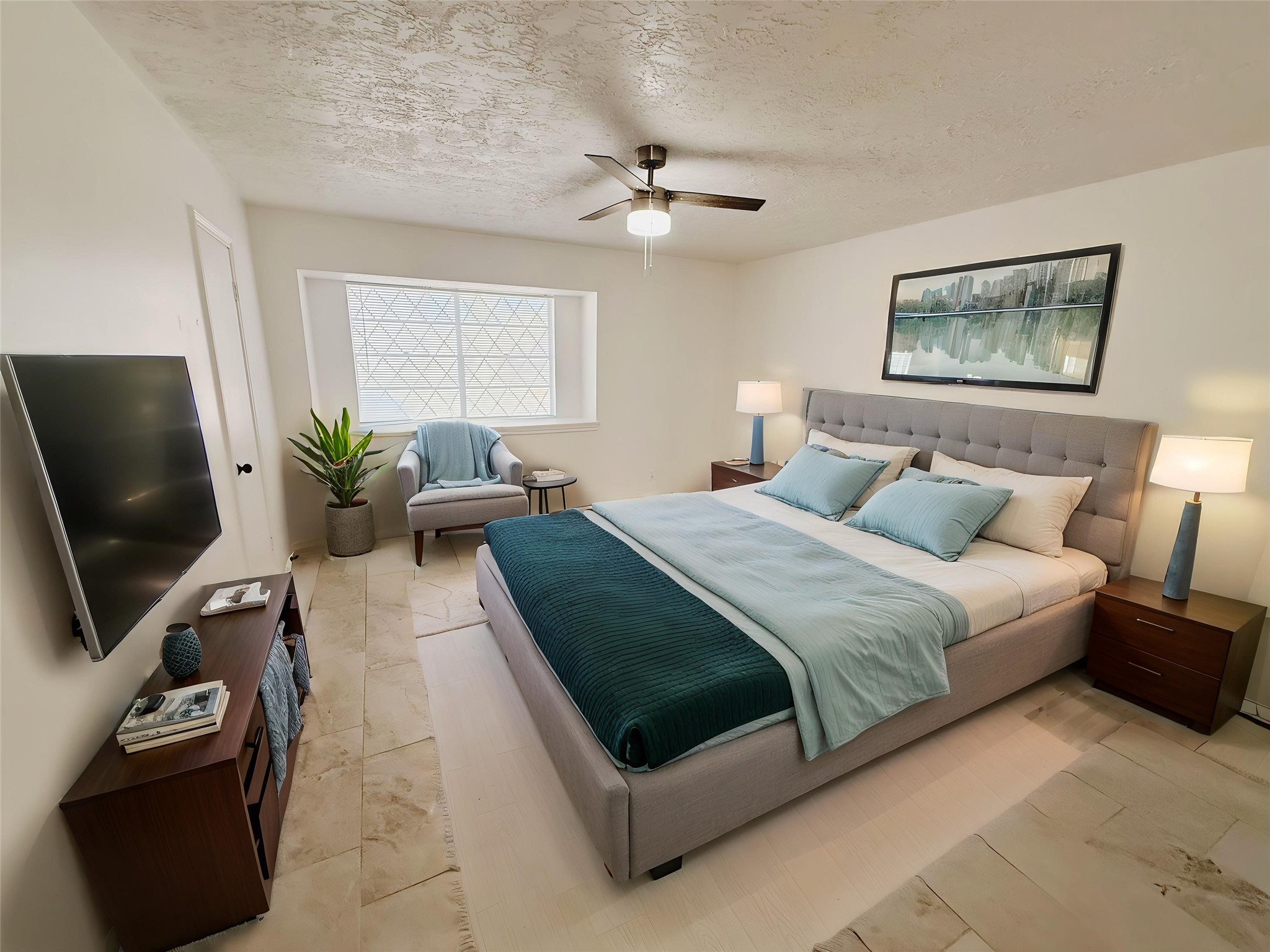 9231 Friendship Road Houston, TX 77080 - Photo 10 of 12 a bedroom with a bed a couch and a flat screen tv