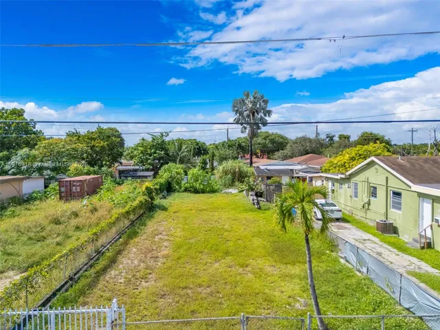 a view of a swimming pool with an outdoor seating and a yard