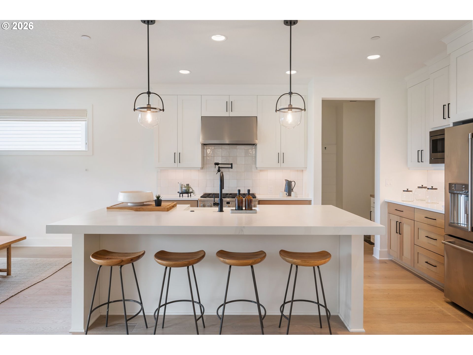 3724 Southwest Hillside Drive Portland, OR 97221 - Photo 11 of 48 a kitchen with stainless steel appliances a stove a sink island and a refrigerator with wooden floor
