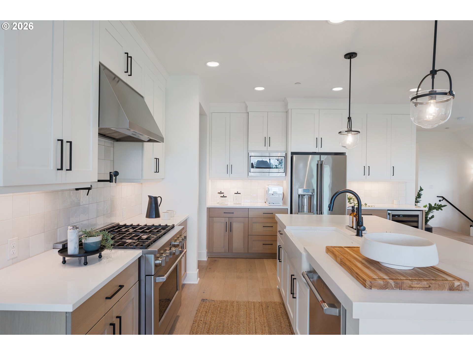 3724 Southwest Hillside Drive Portland, OR 97221 - Photo 13 of 48 a kitchen with kitchen island granite countertop a sink a counter space appliances and cabinets