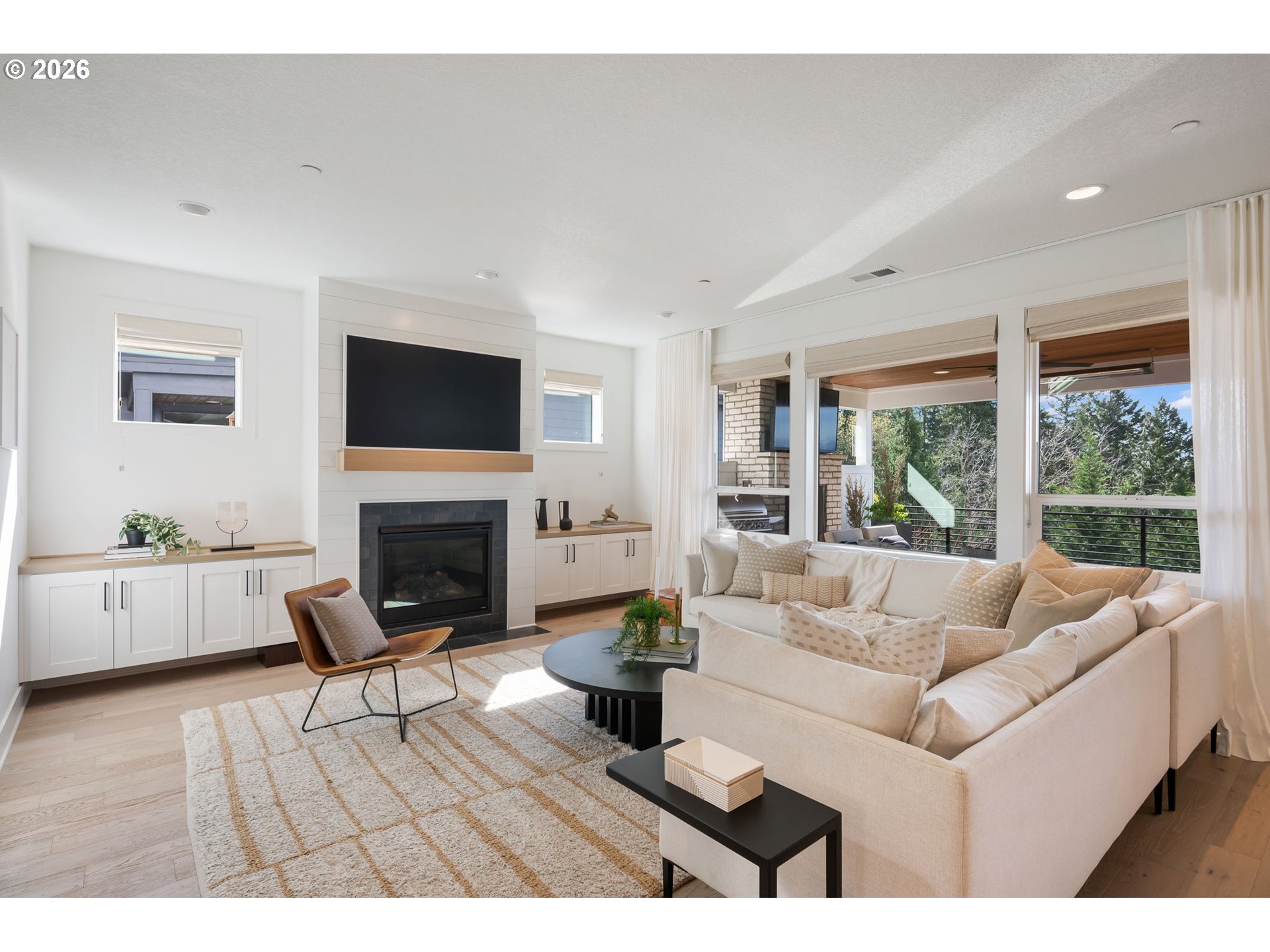 3724 Southwest Hillside Drive Portland, OR 97221 - Photo 4 of 48 a living room with furniture a fireplace and a floor to ceiling window
