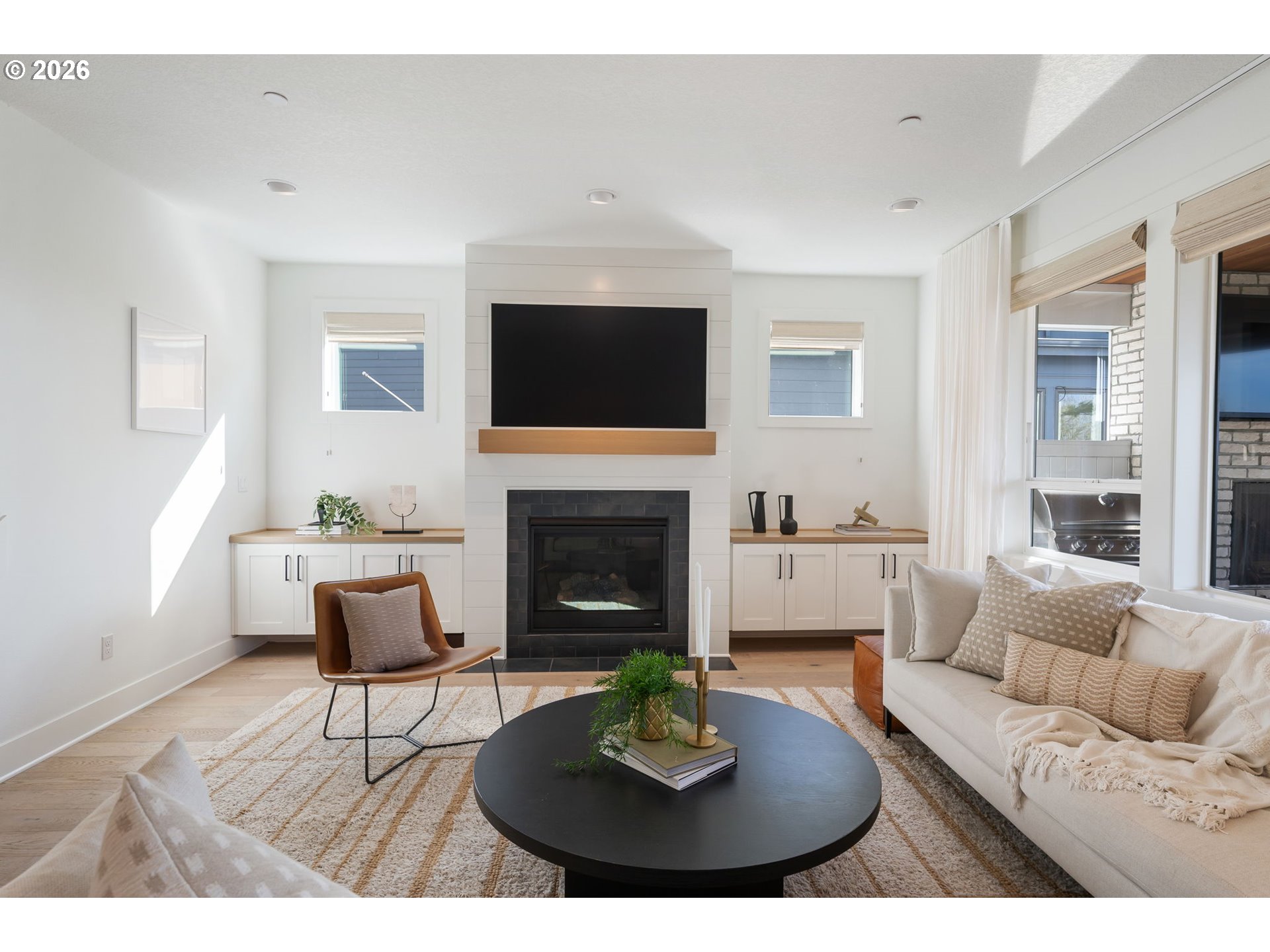 3724 Southwest Hillside Drive Portland, OR 97221 - Photo 5 of 48 a living room with furniture a fireplace and a flat screen tv