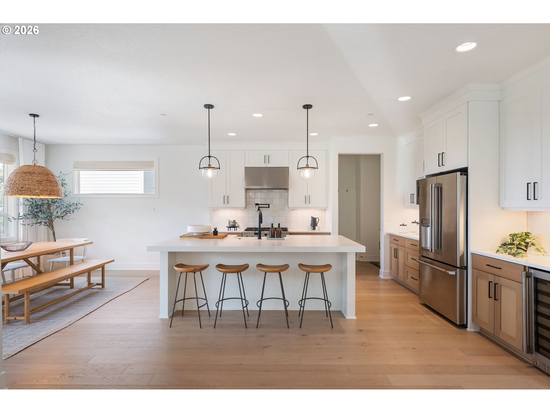 3724 Southwest Hillside Drive Portland, OR 97221 - Photo 9 of 48 a kitchen with stainless steel appliances kitchen island granite countertop a refrigerator a stove a sink dishwasher a dining table and chairs with wooden floor