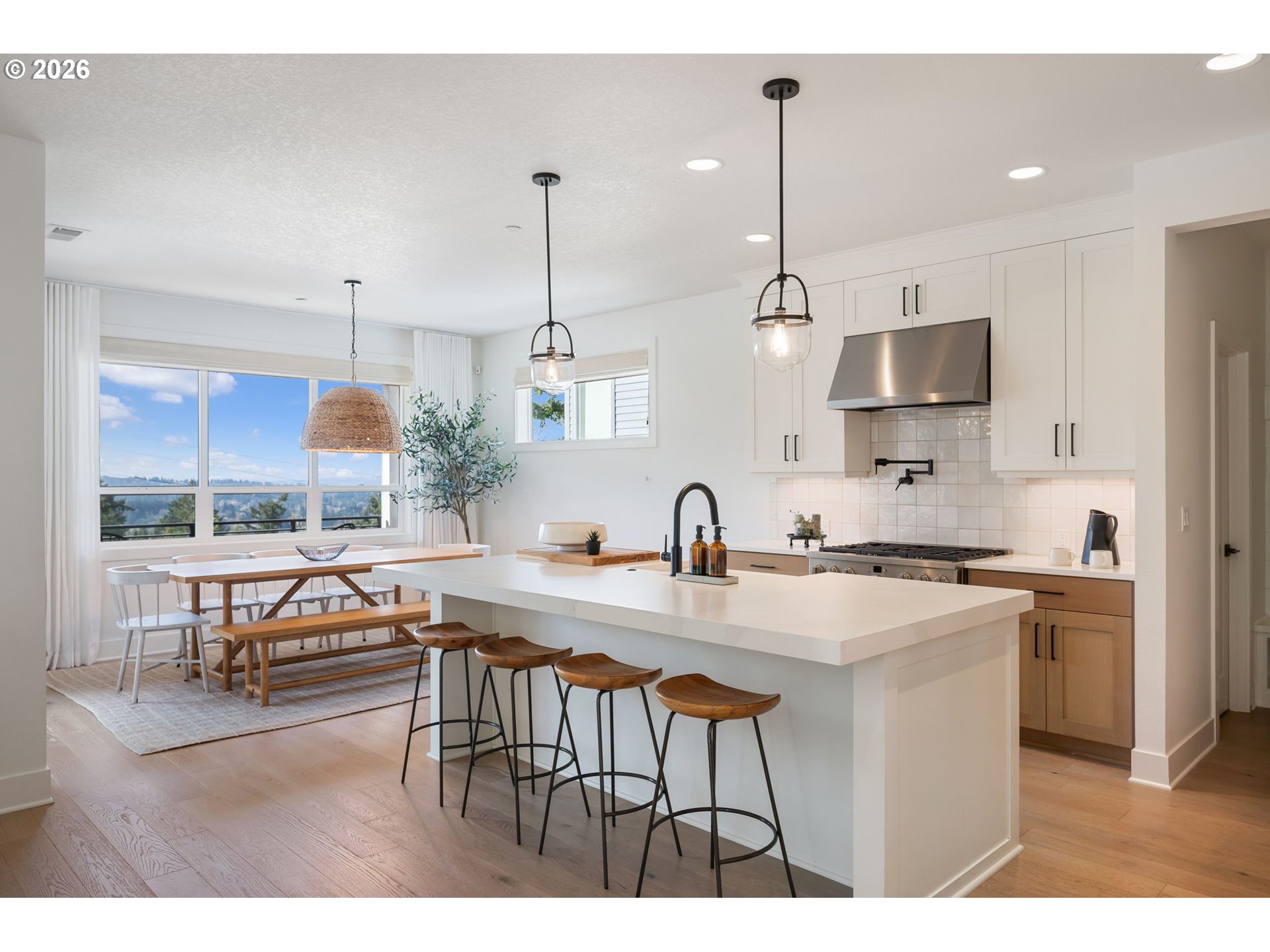 3724 Southwest Hillside Drive Portland, OR 97221 - Photo 10 of 48 a kitchen with kitchen island a stove a table a sink refrigerator and cabinets