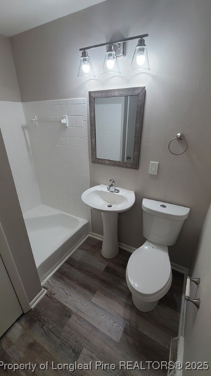 5326 Hampton Road Fayetteville, NC 28311 - Photo 12 of 17 a white toilet sitting next to a bathroom sink and vanity