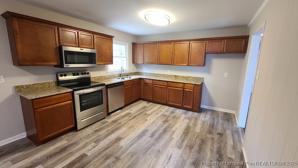 5326 Hampton Road Fayetteville, NC 28311 - Photo 6 of 17 a kitchen with wooden cabinets and stainless steel appliances