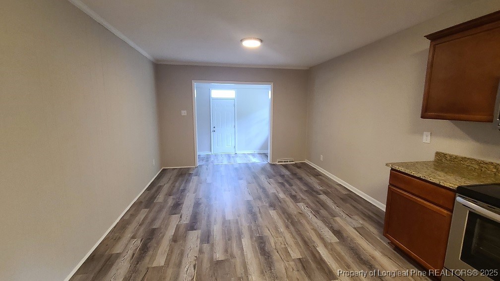 5326 Hampton Road Fayetteville, NC 28311 - Photo 7 of 17 a view of a room with wooden floor and electronic appliances