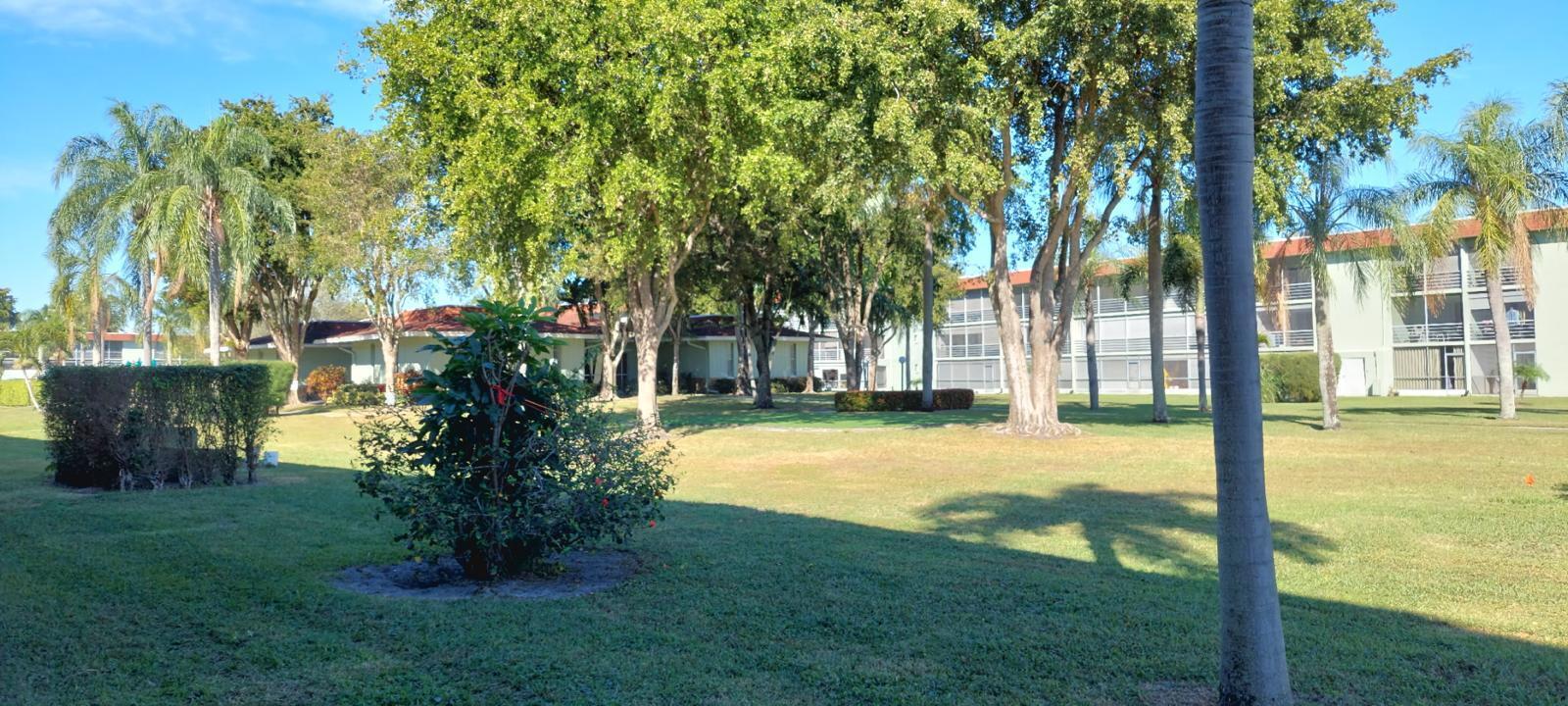 3100 Springdale Boulevard, Unit 317 Palm Springs, FL 33461 - Photo 14 of 18 a view of a house with swimming pool and garden
