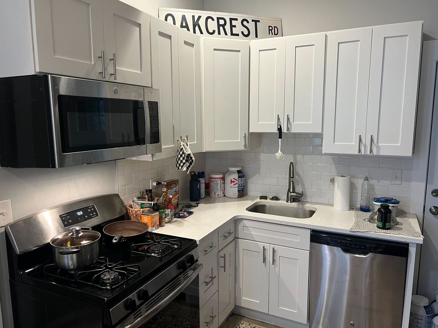 1716 West 19th Street, Unit 2S Chicago, IL 60608 - Photo 4 of 5 a kitchen with stainless steel appliances a stove a sink dishwasher and cabinets with wooden floor
