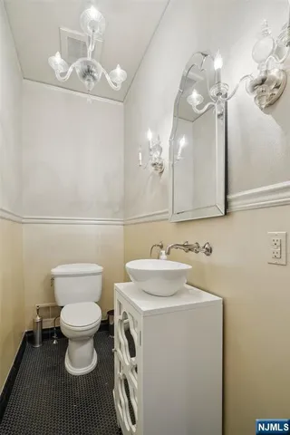 a bathroom with a sink a toilet and a mirror