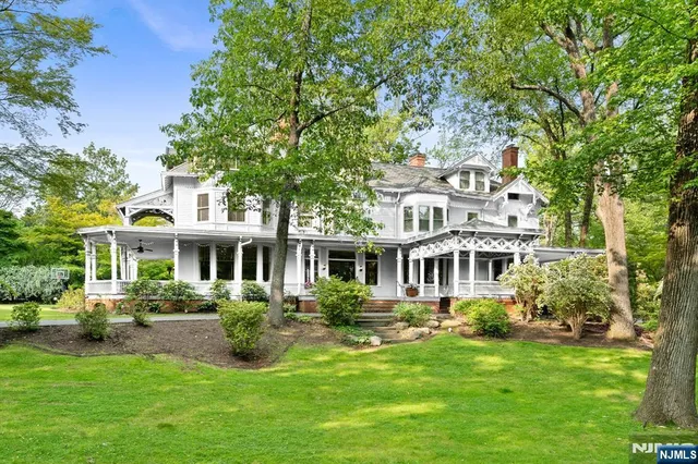 a front view of a house with yard and green space
