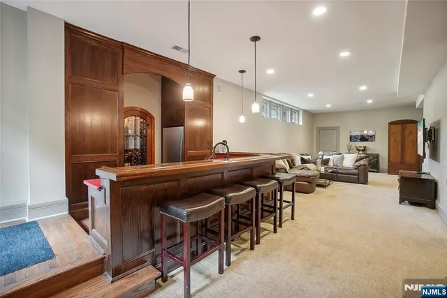 a kitchen with kitchen island a sink dining table and chairs