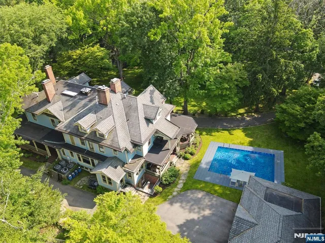an aerial view of a house with a yard basket ball court and outdoor seating