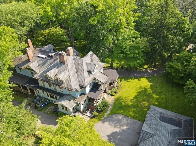 a front view of a house with yard and green space