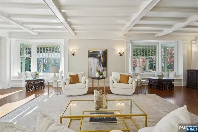 a living room with fireplace furniture and a large window