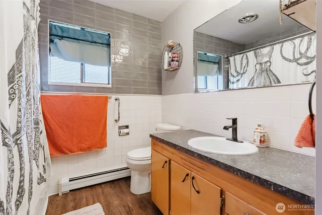 a bathroom with a granite countertop sink and a mirror