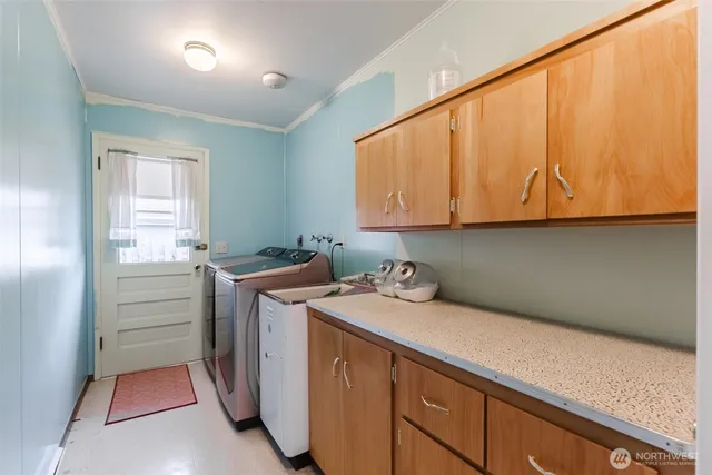 a utility room with sink dryer and washer