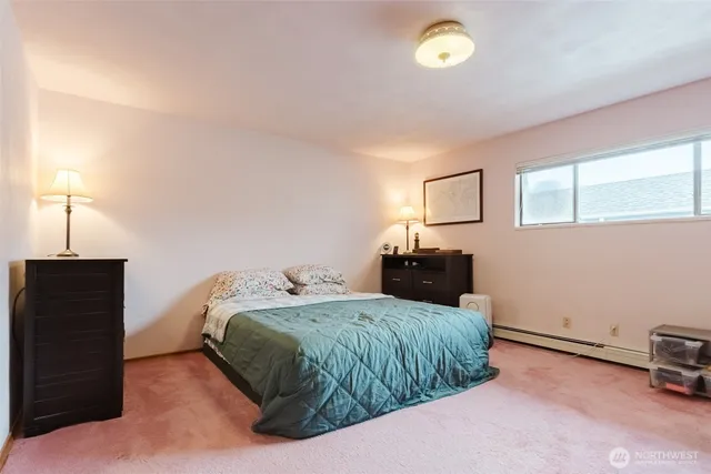 a bedroom with a bed and a lamp